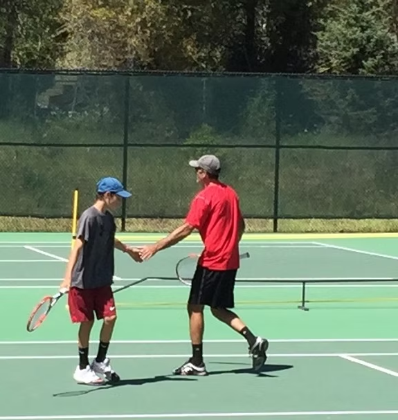 mike shaking hands with another tennis player